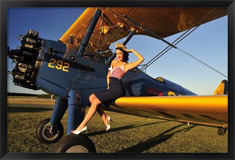 Framed 1940&#39;s style pin-up girl sitting on the wing of a Stearman biplane Print