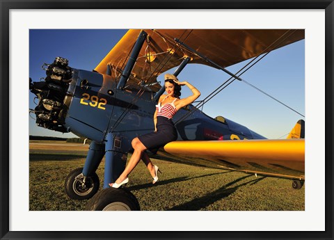 Framed 1940&#39;s style pin-up girl sitting on the wing of a Stearman biplane Print