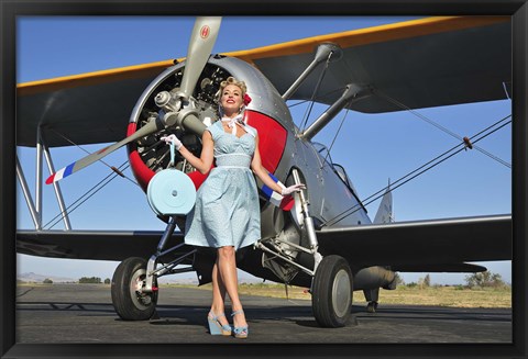 Framed Elegant 1940&#39;s style pin-up girl standing in front of an F3F biplane Print