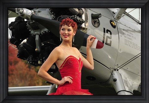 Framed Redhead pin-up girl in 1940&#39;s style dancer attire holding on to a vintage aircraft propeller Print