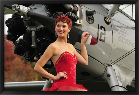 Framed Redhead pin-up girl in 1940&#39;s style dancer attire holding on to a vintage aircraft propeller Print