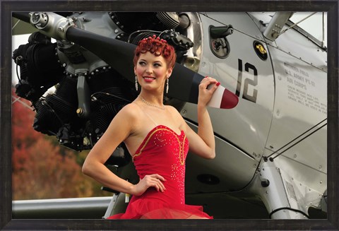 Framed Redhead pin-up girl in 1940&#39;s style dancer attire holding on to a vintage aircraft propeller Print