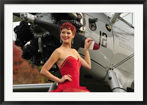 Framed Redhead pin-up girl in 1940&#39;s style dancer attire holding on to a vintage aircraft propeller Print