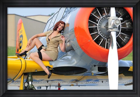 Framed 1940&#39;s style pin-up girl posing on a T-6 aircraft Print