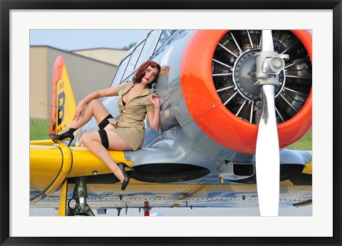 Framed 1940&#39;s style pin-up girl posing on a T-6 aircraft Print