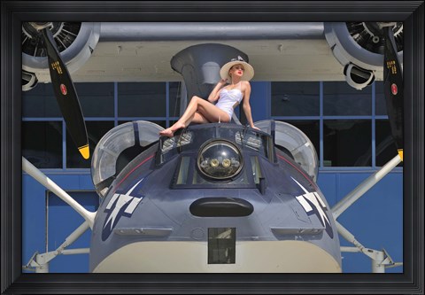 Framed Retro pin-up girl posing with a World War II era PBY Catalina seaplane Print