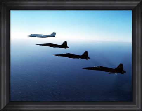 Framed Three F-5E Tiger IIs fly in formation with a Learjet 25 Print