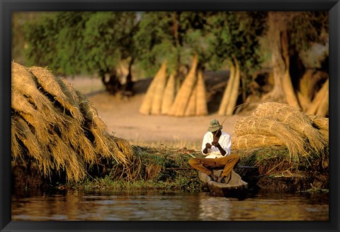 Framed Local Man Fishing and Piles of Straw for Hatch, Okavango Delta, Botswana Print