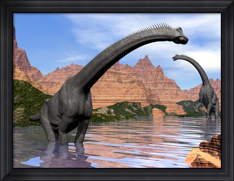 Framed Two Brachiosaurus dinosaurs in water next to red rock mountains Print