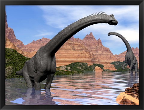 Framed Two Brachiosaurus dinosaurs in water next to red rock mountains Print