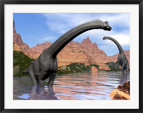 Framed Two Brachiosaurus dinosaurs in water next to red rock mountains Print