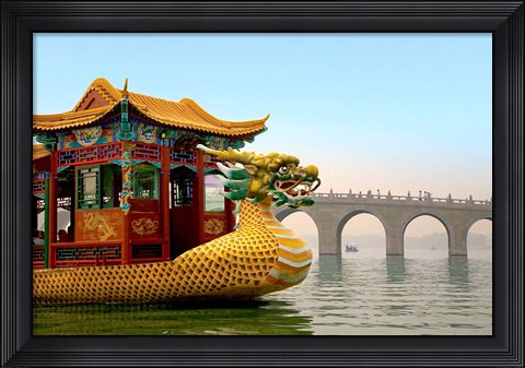Framed Summer Palace, a traditional Dragon Boat passes the Seventeen Arch Bridge, Kunming lake, Beijing, China Print