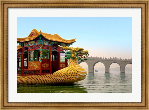 Framed Summer Palace, a traditional Dragon Boat passes the Seventeen Arch Bridge, Kunming lake, Beijing, China Print