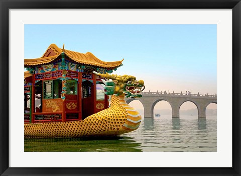 Framed Summer Palace, a traditional Dragon Boat passes the Seventeen Arch Bridge, Kunming lake, Beijing, China Print