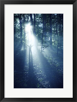 Framed Silhouette of a man standing in the misty rays of a dark forest, Denmark Print