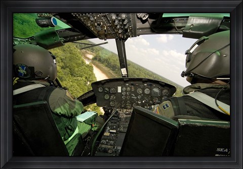 Framed Two instructor pilots practice low flying operations in a UH-1H Huey helicopter Print