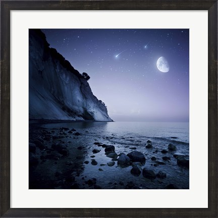 Framed Rising moon over ocean and mountains against starry sky Print