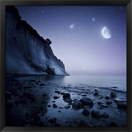 Framed Rising moon over ocean and mountains against starry sky Print