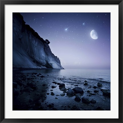 Framed Rising moon over ocean and mountains against starry sky Print