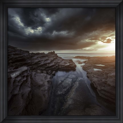 Framed Huge rocks on the shore of a sea against stormy clouds, Sardinia, Italy Print