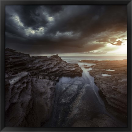 Framed Huge rocks on the shore of a sea against stormy clouds, Sardinia, Italy Print