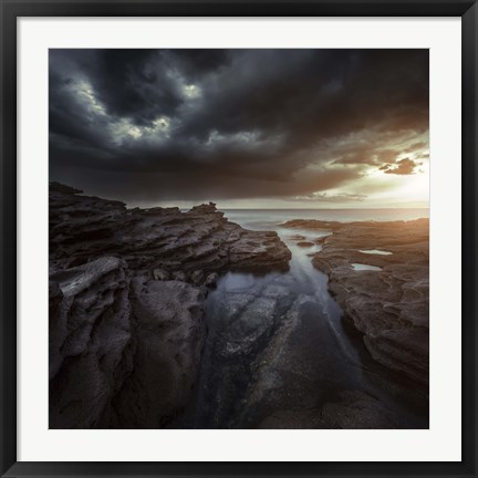 Framed Huge rocks on the shore of a sea against stormy clouds, Sardinia, Italy Print
