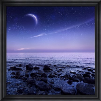 Framed Moon rising over rocky seaside against starry sky Print