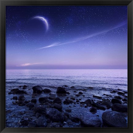 Framed Moon rising over rocky seaside against starry sky Print