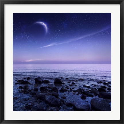 Framed Moon rising over rocky seaside against starry sky Print