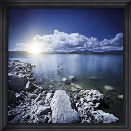 Framed Tranquil lake and rocky shore with sun over horizon, Sardinia, Italy Print