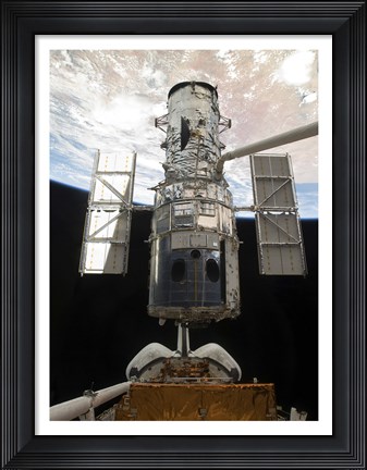Framed Space Shuttle Atlantis&#39; arm lifts the Hubble Space Telescope from the cargo bay Print