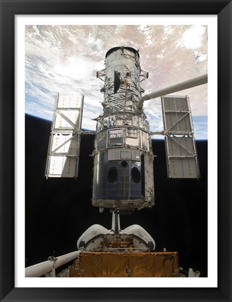 Framed Space Shuttle Atlantis&#39; arm lifts the Hubble Space Telescope from the cargo bay Print