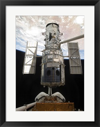 Framed Space Shuttle Atlantis&#39; arm lifts the Hubble Space Telescope from the cargo bay Print
