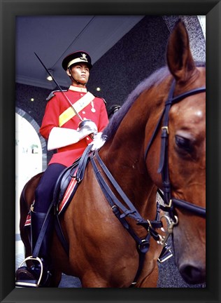 Framed Malaysia, Kuala Lumpur: a mounted guard stands in front of the Royal Palace Print