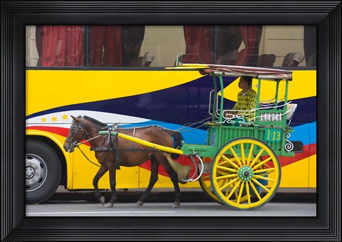 Framed Horse cart walk by colorfully painted bus, Manila, Philippines Print