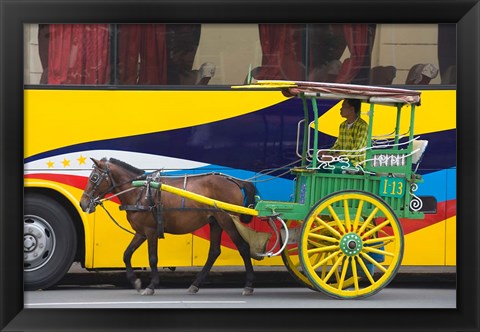 Framed Horse cart walk by colorfully painted bus, Manila, Philippines Print