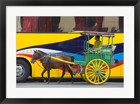 Framed Horse cart walk by colorfully painted bus, Manila, Philippines Print