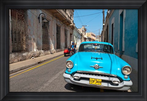 Framed Cuba, Camaquey, Oldsmobile car and buildings Print