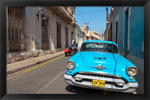 Framed Cuba, Camaquey, Oldsmobile car and buildings Print