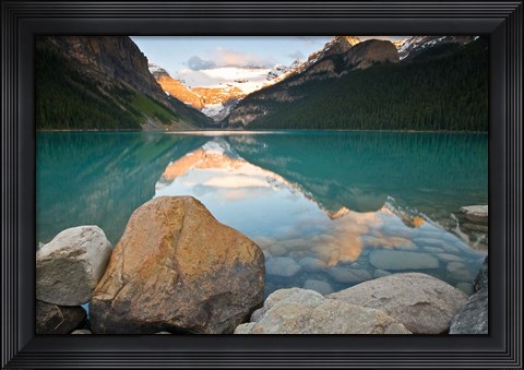 Framed Rocky Mountains and boulders reflected in Lake Louise, Banff National Park, Alberta, Canada Print