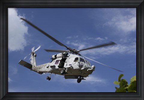 Framed Crew Chief looks out the side door of a helicopter in flight Print
