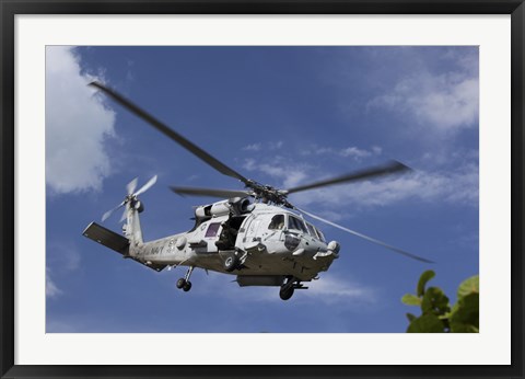 Framed Crew Chief looks out the side door of a helicopter in flight Print