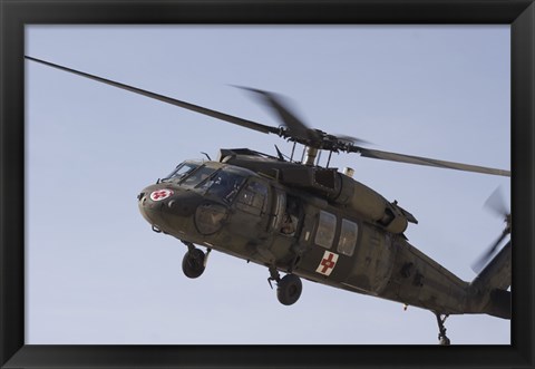 Framed UH-60 Blackhawk Medivac helicopter flies over Camp Warhorse Print