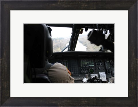 Framed UH-60 Blackhawk flies the River to an Unknown Village to Drop off a Care Package Print