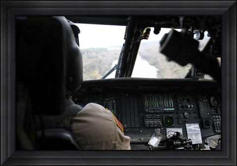 Framed UH-60 Blackhawk flies the River to an Unknown Village to Drop off a Care Package Print