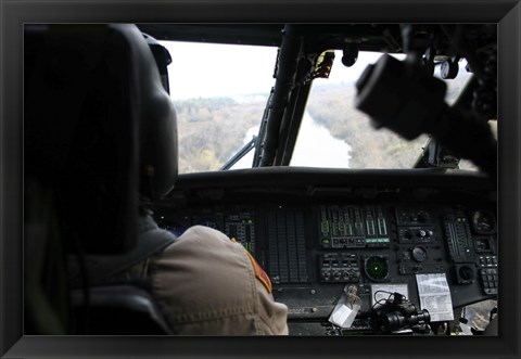 Framed UH-60 Blackhawk flies the River to an Unknown Village to Drop off a Care Package Print