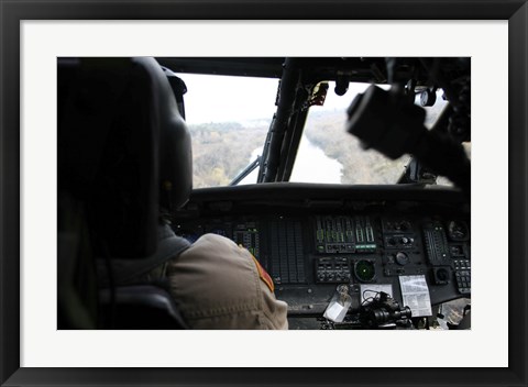 Framed UH-60 Blackhawk flies the River to an Unknown Village to Drop off a Care Package Print