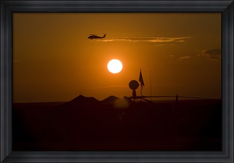 Framed UH-60 Blackhawk Flies Over Camp Speicher Airfield at Sunset Print