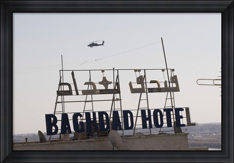 Framed AH-64 Apache in flight over the Baghdad Hotel in central Baghdad, Iraq Print