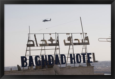 Framed AH-64 Apache in flight over the Baghdad Hotel in central Baghdad, Iraq Print